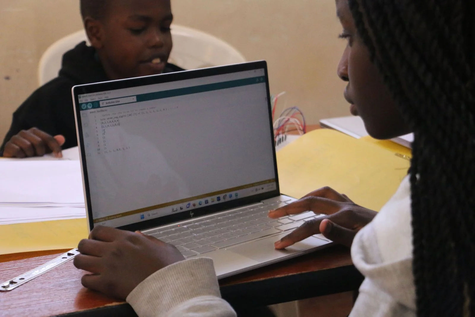 Learners exploring programming on a laptop