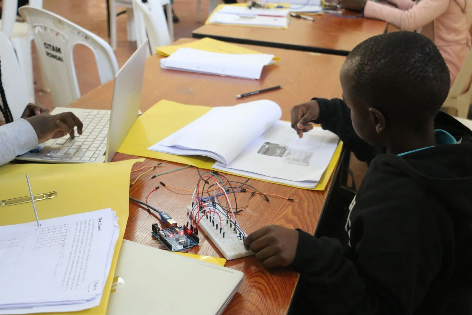 A learner experimenting with an electronics kit